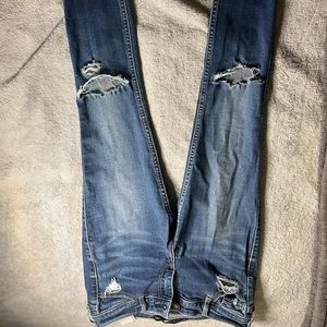 Low rise, dark blue jeans, they have a small slit both sides